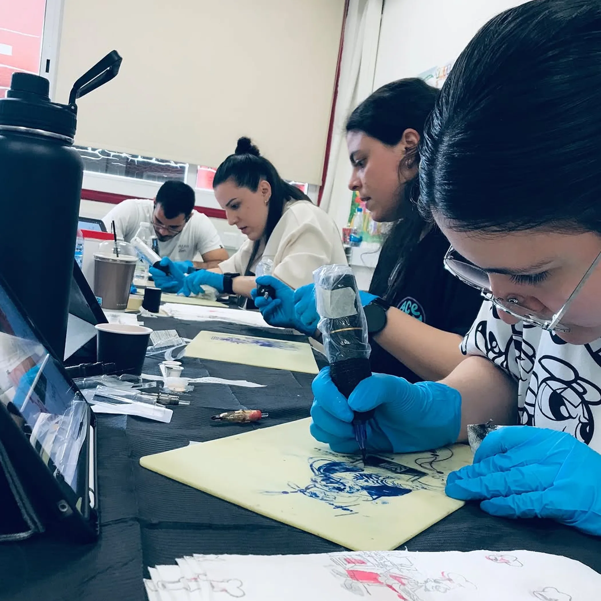 people practicing tattooing training