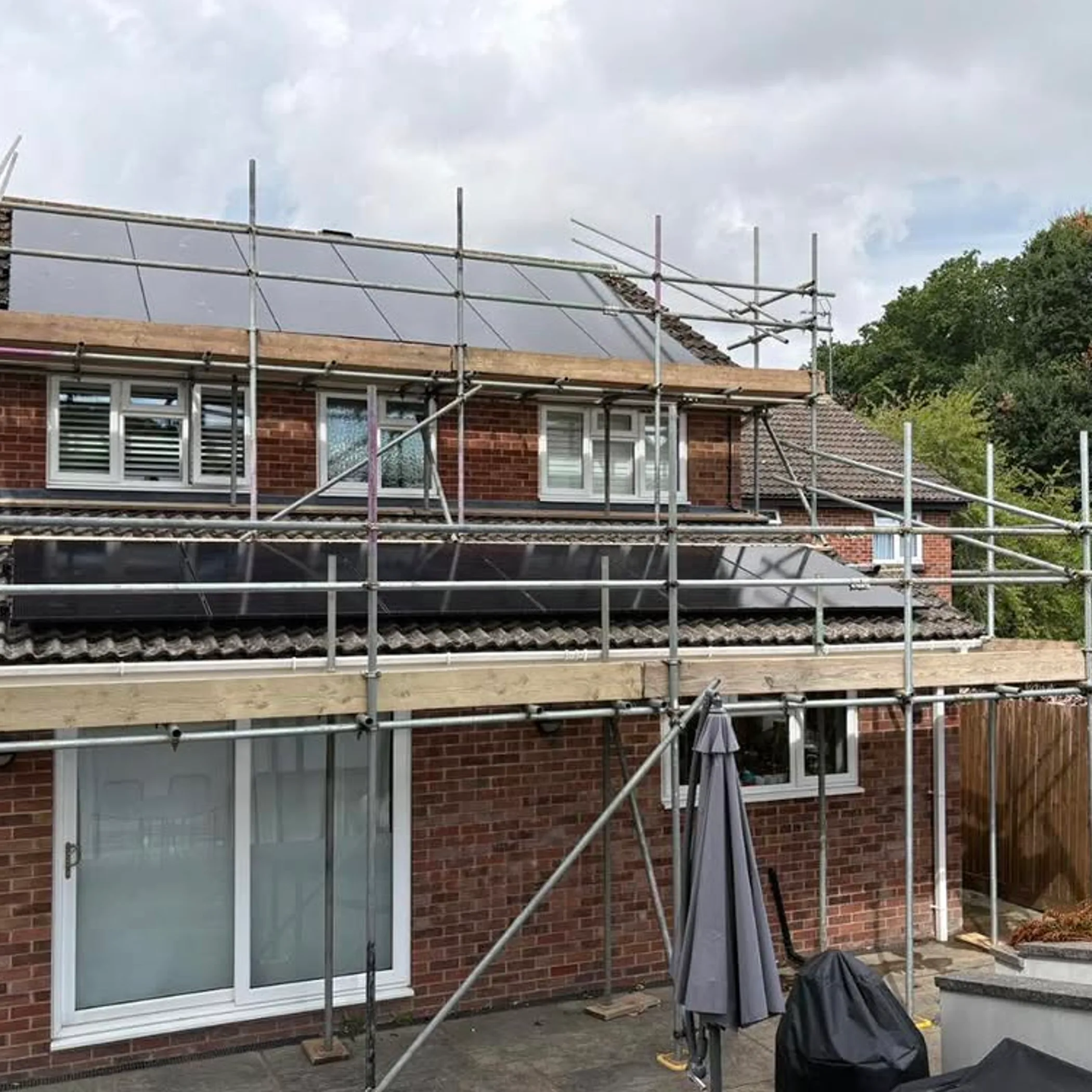 rooftop solar panels being maintained