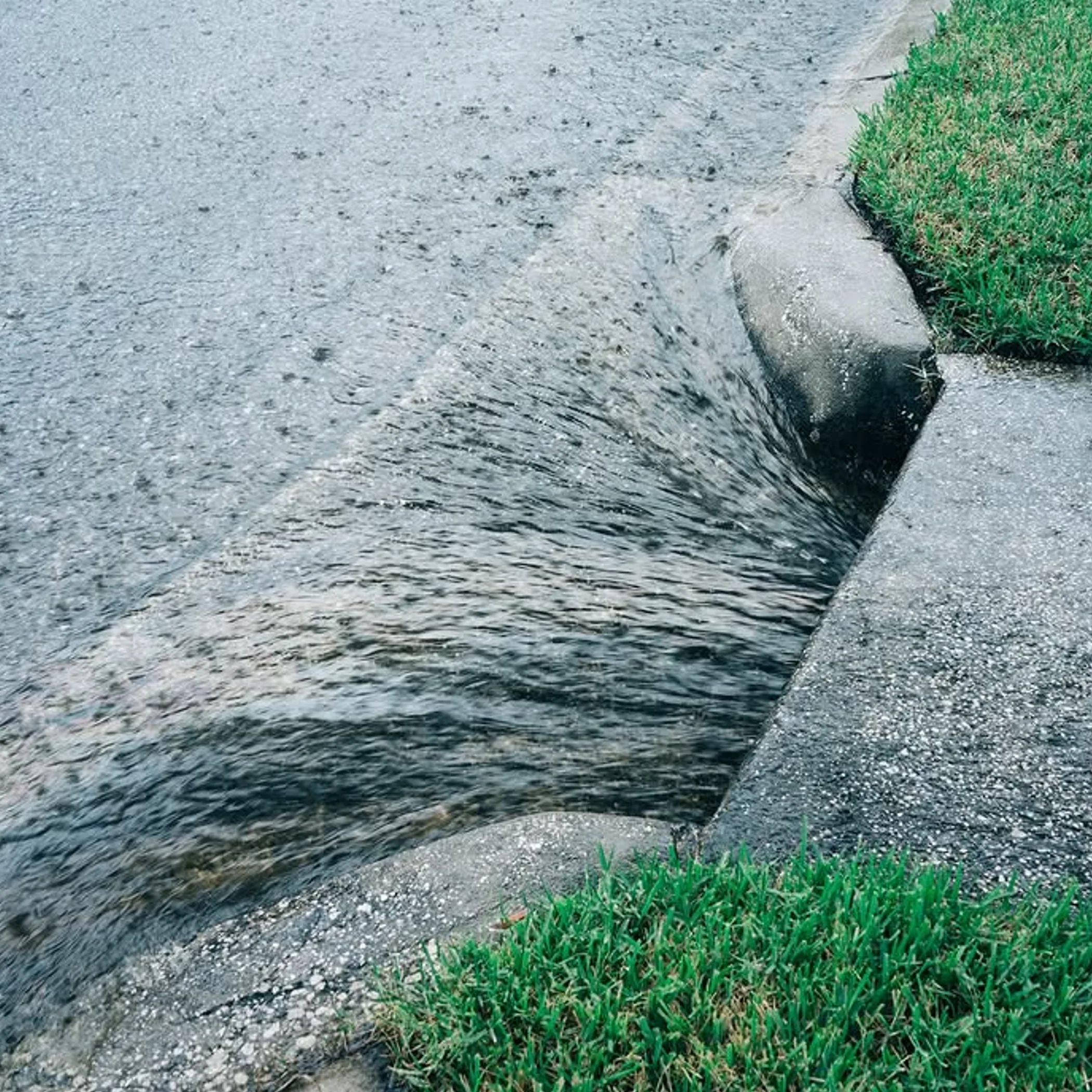 stormwater flowing through curb channel